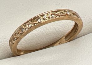 A 9ct gold diamond set "Infinity" eternity ring. Pierced work infinity decoration to top with a