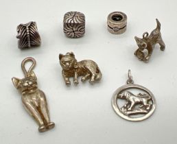 A small collection of silver and white metal charms and pendants to include cats, Leo zodiac sign
