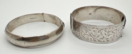 2 vintage silver bangles. A plain bangle with push clasp, marked Sterling, together with a 2.25cm