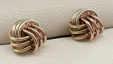 A pair of 9ct gold tri coloured gold knot stud style earrings with butterfly backs. Test as 9ct