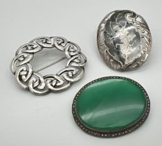 3 vintage silver brooches. A Celtic design circular brooch, an oval brooch set with a green stone
