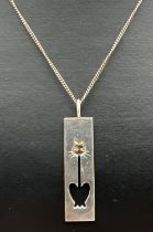 A modern design silver pierced work cat pendant with gold plated accent, on an 18" fine curb chain