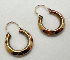 A pair of vintage 9ct gold hoop earrings decorated with diamond shaped pattern throughout.