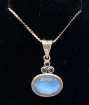 A modern silver design moonstone and sapphire pendant on a 16" fine snail chain with spring ring