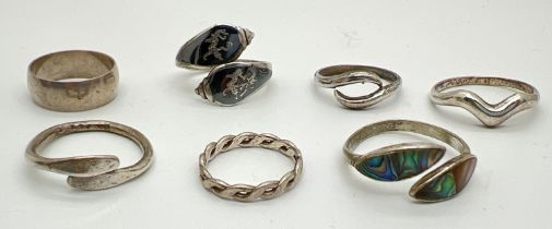 7 silver and white metal band style rings. To include Siam silver with Thai dancers decoration and