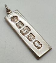 A vintage silver ingot pendant with hanging bale. Full hallmarks to front for Sheffield 1977.