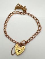 A vintage 9ct rose gold belcher chain link bracelet with yellow gold floral engraved padlock &