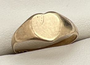 A vintage 9ct gold heart shaped signet ring with worn floral engraved detail to front. Full