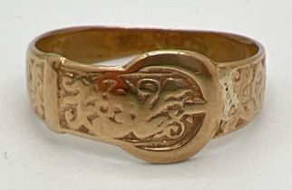 A vintage 10K gold buckle ring with engraved foliate decoration. Marked 10K to inside of band.