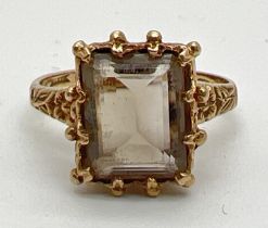 A vintage 9ct gold, claw set smoked quartz dress ring. Central emerald cut smoked quartz in