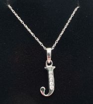A 9ct white gold, diamond set initial "J" pendant on a fine 16" belcher chain with spring ring