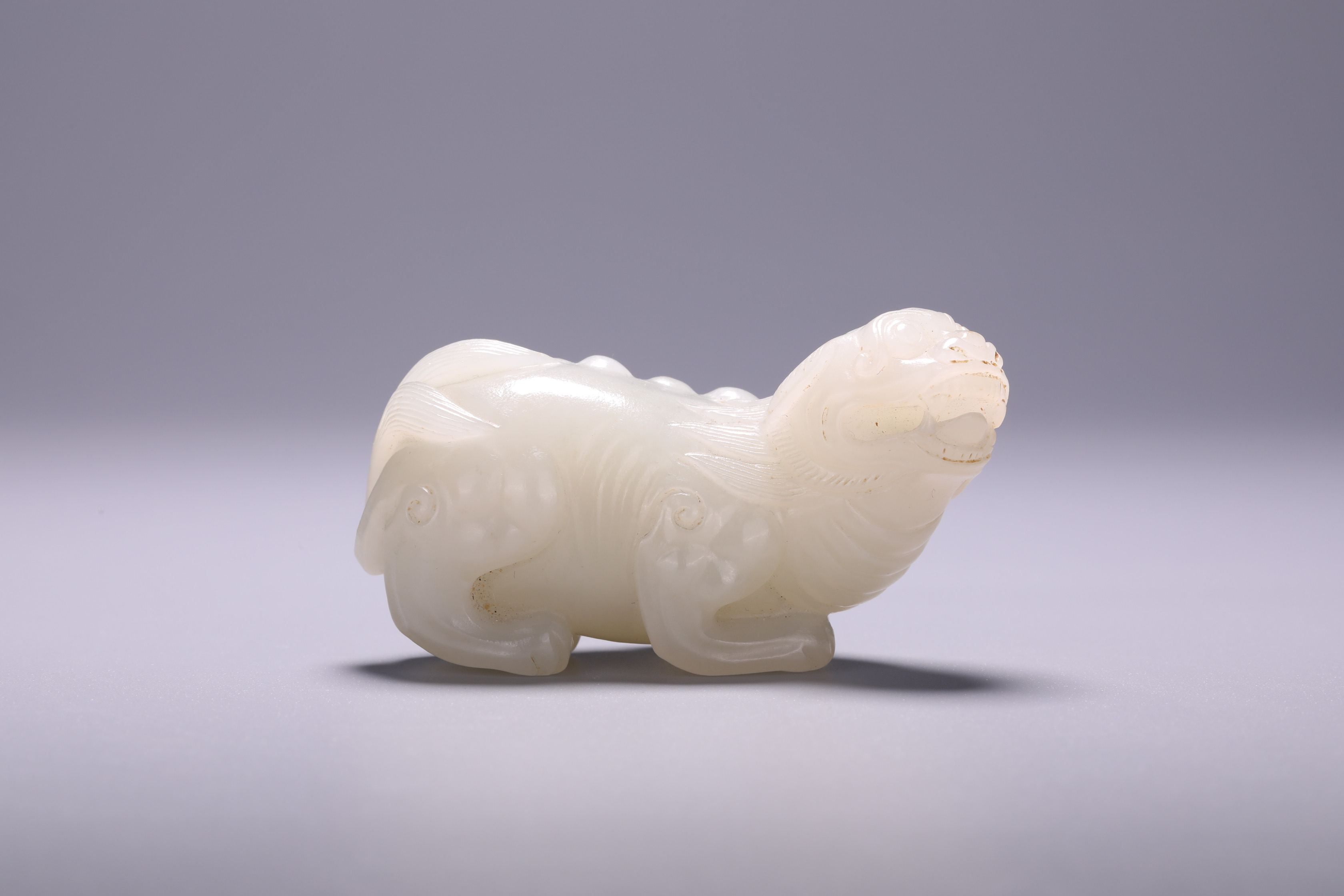 A Chinese jade 'Mythical Beast' carving, L 6,5 - H 3,5 cm