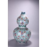 A Chinese famille rose 'Scrolling Lotus' double gourd vase, Qianlong mark, H 56,5 cm