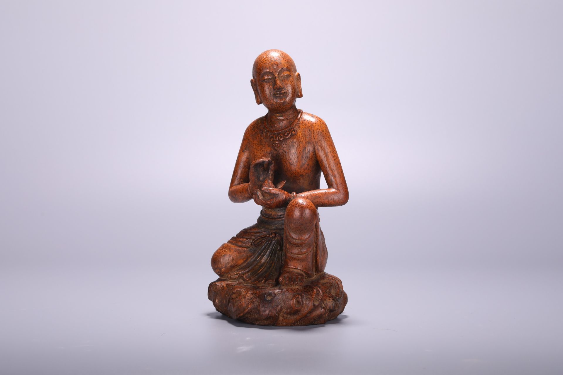 A Chinese bamboo carving of a Louhan, H 22 cm