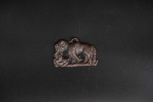 An Ordos 'Wolf and Goat' Plaque, Han dynasty, the fierced wolf cast in low pierced relief