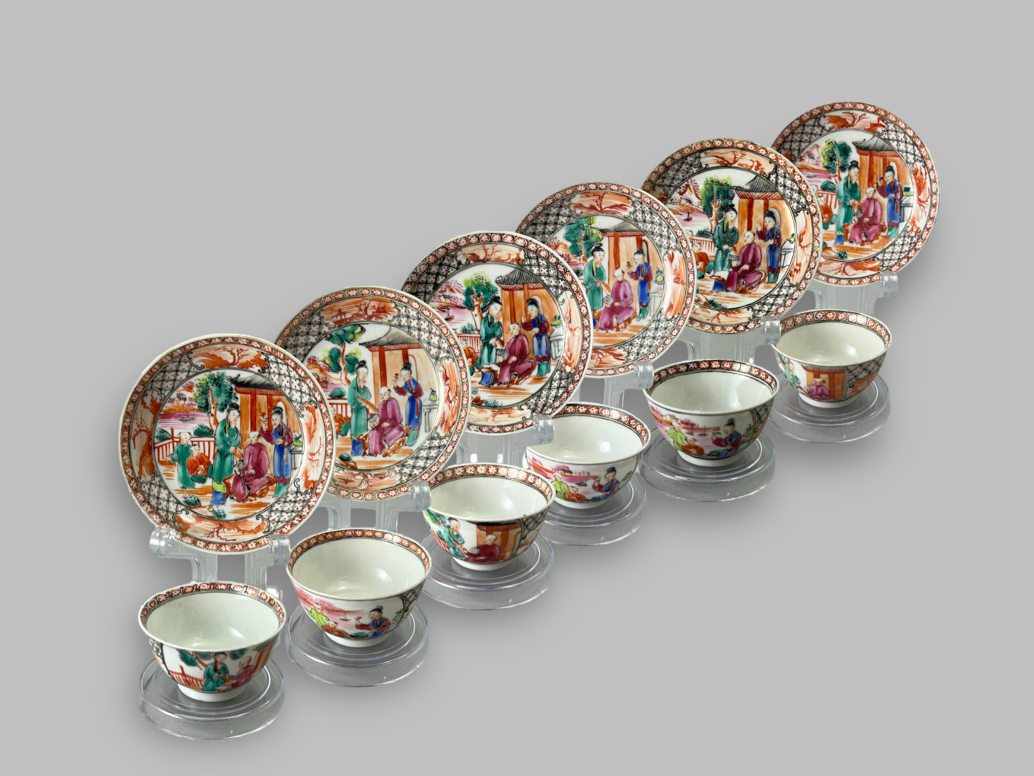 A Set of Six 'Mandarin Palette' Cups and Saucers, Qianlong, with a central family lakeside terrace