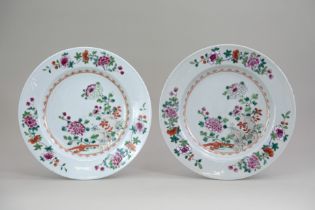 A Pair of 'famille rose' Plates, Qianlong, with chrysanthemums and garden rocks, within gilt