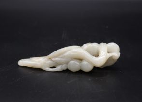 A Jade Magpie and Lingzhi Paperweight, 19th century, the celadon stone carved with the bird biting