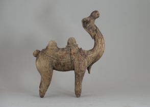 A Rare Wooden Carved Camel, Tang dynasty or later, wooden carved in camel shape, with its head