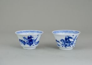 A Pair of Blue and White 'Hunting' Cups, Qing dynasty, painted with a frieze of Chinese riders and