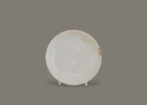 A small Ding-type dish, Northern Song Dynasty, with shallow flared sides resting on a flat base,