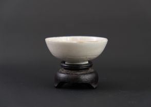 A Miniature Dingyao Winecup, Northern Song dynasty, of rounded shallow form with square cut footrim,