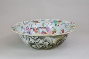 A 'famille rose' Basin, 19th century, with a central medallion of a lady dancer and musicians, the