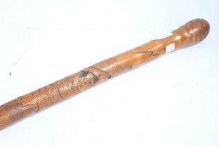 Japanese bamboo walking stick, carved with a figure fighting a serpent, signed to lower section,