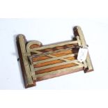 Victorian novelty oak and brass pipe rack, modelled as a six bar gate, with five recesses for pipes,