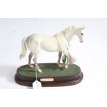 Royal Doulton horse 'Desert Orchid' raised on wooden plinth, with original box, 23cm wide