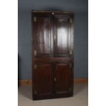 18th century oak panelled corner cupboard, having two pairs of doors, the upper doors enclosing a