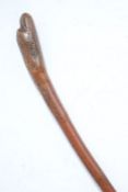 Carved wooden folk art waking stick, with birds head handle, 79cm long