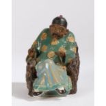 20th Century Chinese porcelain figure depicting a gentleman seated in a naturalistically modelled
