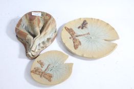 Two Bernard Rooke pottery dishes, in the form of lily pads with dragonflies, and a pottery wall