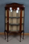 Edwardian mahogany and inlaid bowfront display cabinet, having shaped gallery top above a single