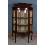 Edwardian mahogany and inlaid bowfront display cabinet, having shaped gallery top above a single