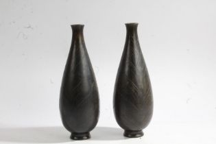 Pair of Japanese bronze vases, Meiji period, the bulbous bodies with stylised leaf decoration,
