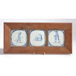 Three 18th century Delft blue & white figural tiles, framed as one, 21.5cm x 47cm.