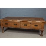 Indian Teak Thakat coffee table, the rectangular top above two drawers raised on turned legs,