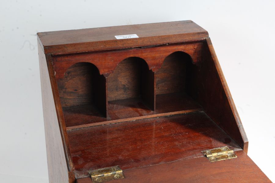 A 19th Century mahogany miniature bureau, the fall above three long drawers, on ogee bracket feet, - Image 2 of 2