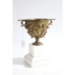 19th Century bronze twin handled urn, with cast foliate decoration, raised on a white marble