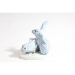 Herend model of two rabbits, by Eva Vastagh, with a shaped base with marks "Vastag Eva 1928", with a