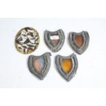 Four 19th century stain glass panels of shield form with lead mounts enclosing stained glass