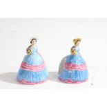 Pair of Carlton Ware napkin holders depicting ladies in a blue and pink dress, 10cm high