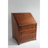 A 19th Century mahogany miniature bureau, the fall above three long drawers, on ogee bracket feet,