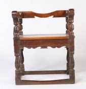 An oak chair, 17th century & later, low-back, scroll arms, solid seat, turned supports and legs,