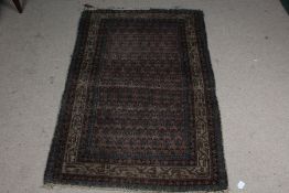 Early 20th century Afghanistan style wool rug, with original retailers webbing for Chamberlain