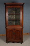 George III oak corner cabinet, having a glazed door opening to reveal three shelves and having a