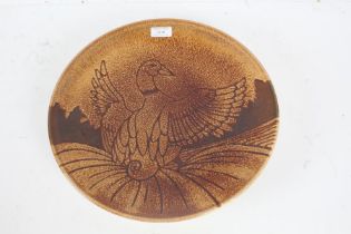 Poole pottery "Aegean" charger, decorated with a bird on brown ground, 35cm diameter