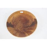 Poole pottery "Aegean" charger, decorated with a bird on brown ground, 35cm diameter